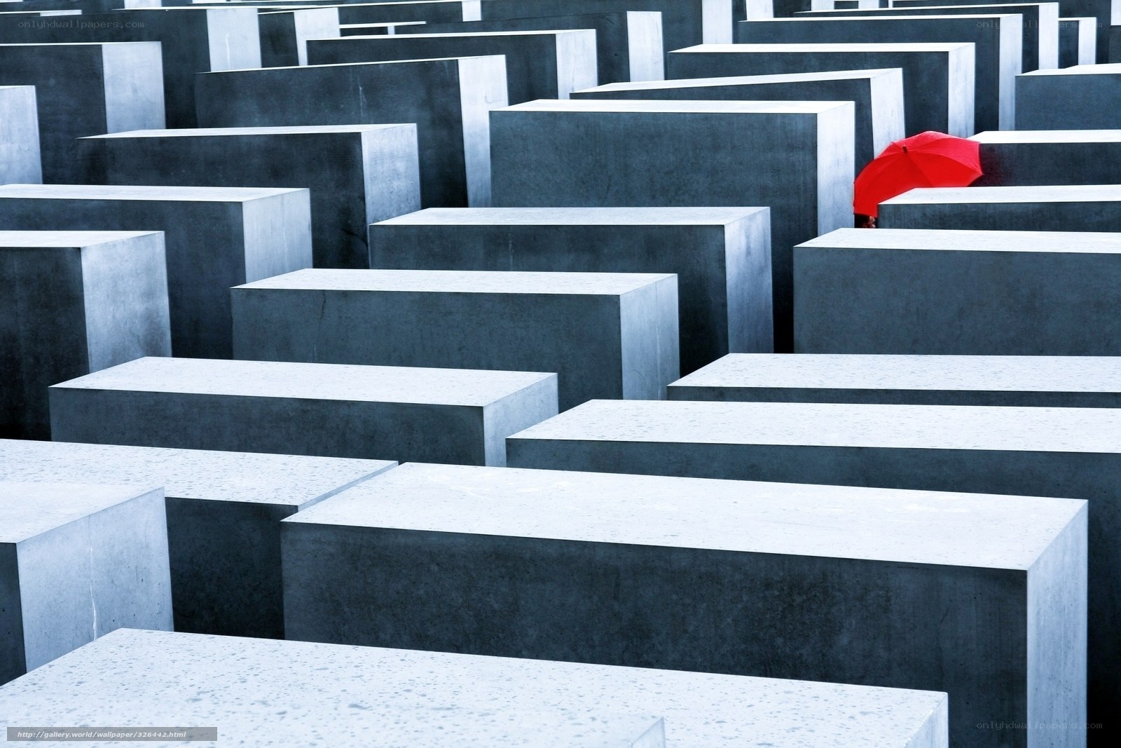 Red umbrella in a stone maze