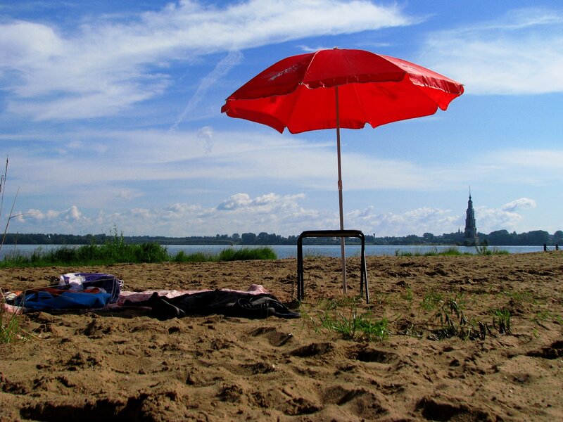 Red umbrella on sandy beach