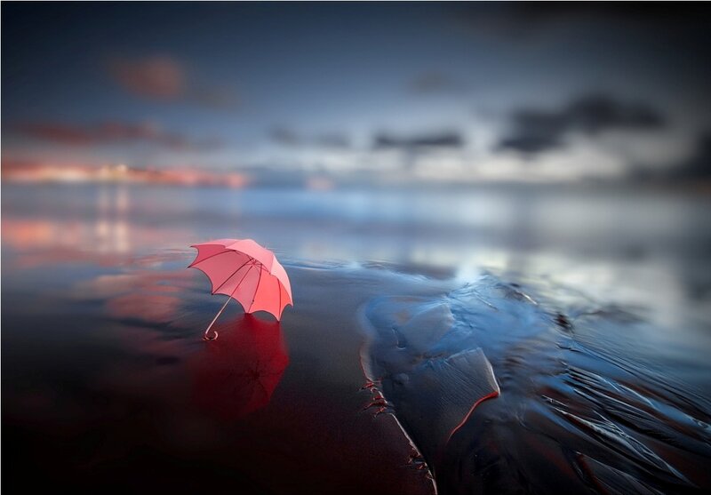 Red Umbrella on Wet Sand