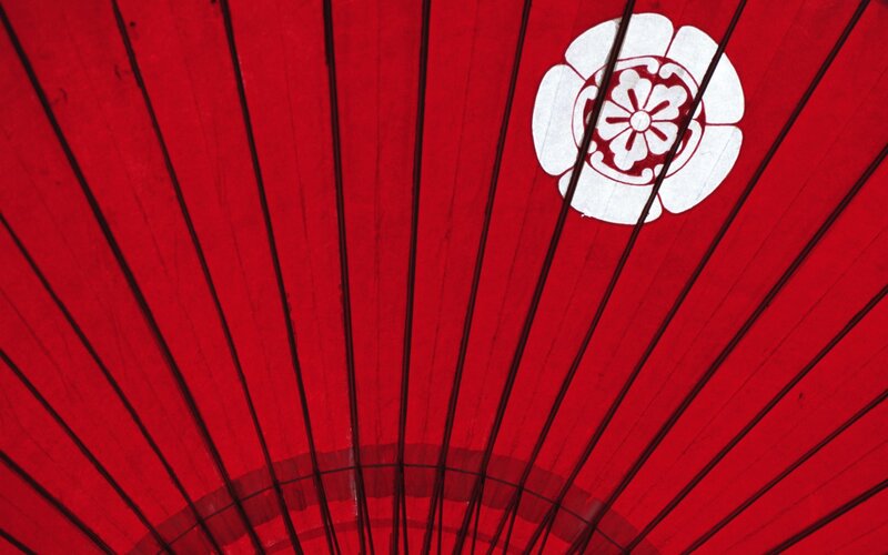 Red umbrella with white emblem