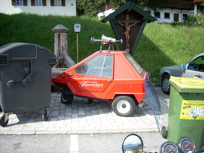 Red vehicle near a crucifix