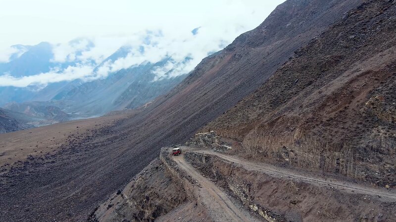Red Vehicle on Mountain Road