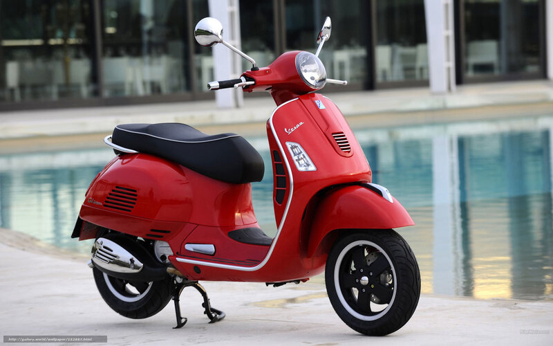 Red Vespa scooter by pool