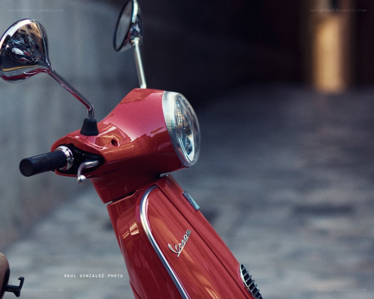 Red Vespa scooter front view