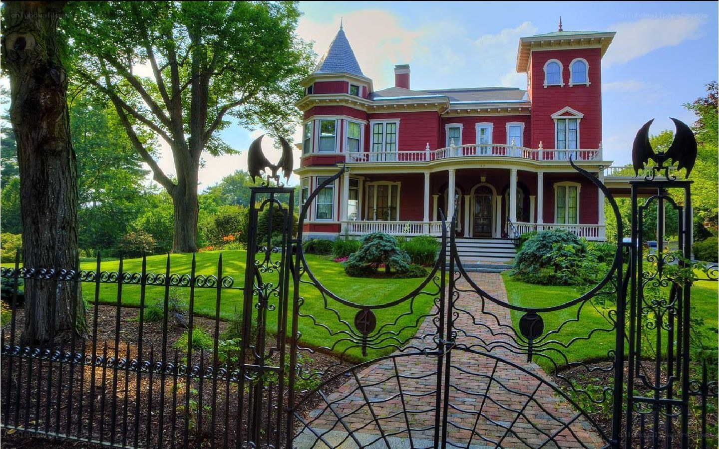 Red Victorian house with bat gates