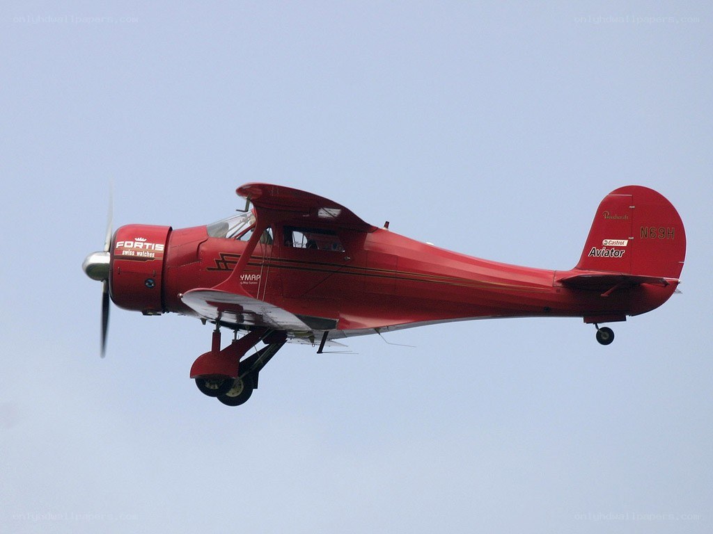 Red vintage airplane in flight
