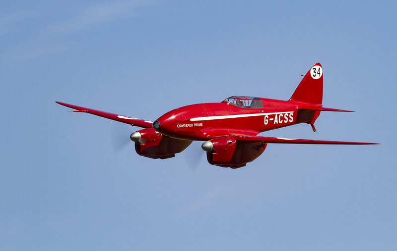 Red vintage airplane in flight