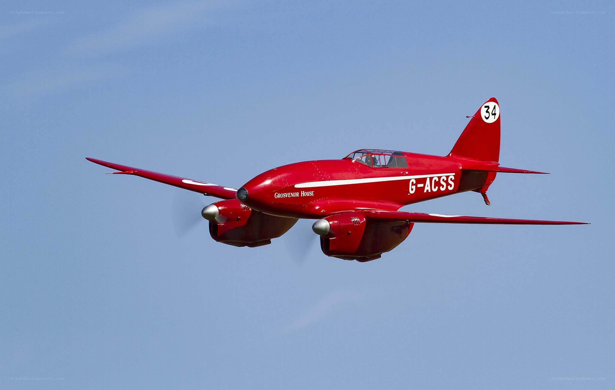 Red vintage airplane in flight
