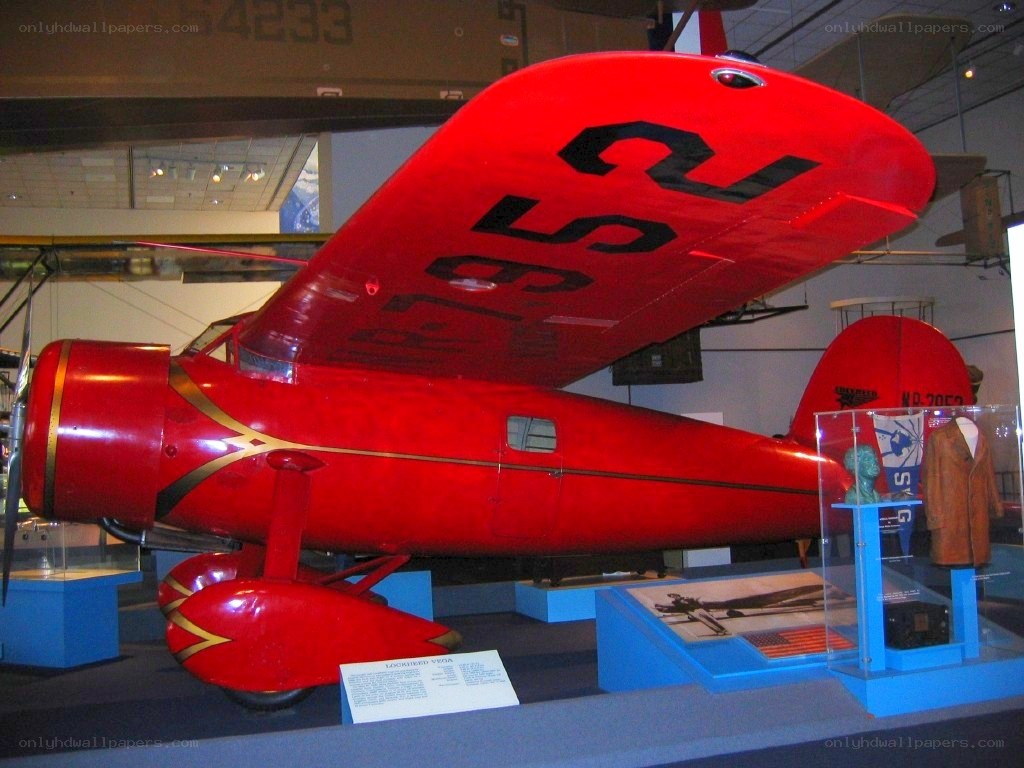 Red vintage airplane on display