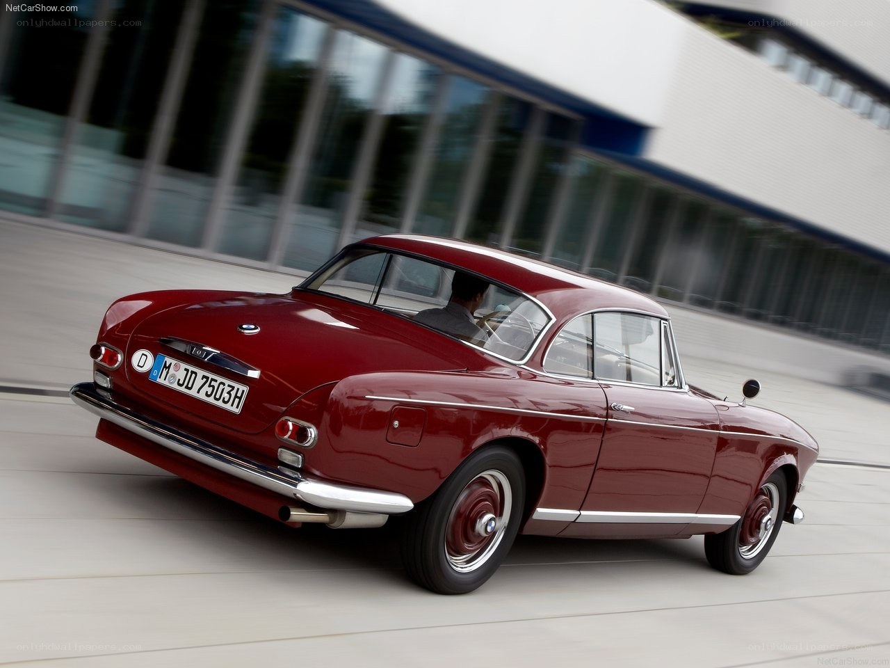 Red vintage BMW coupe in motion
