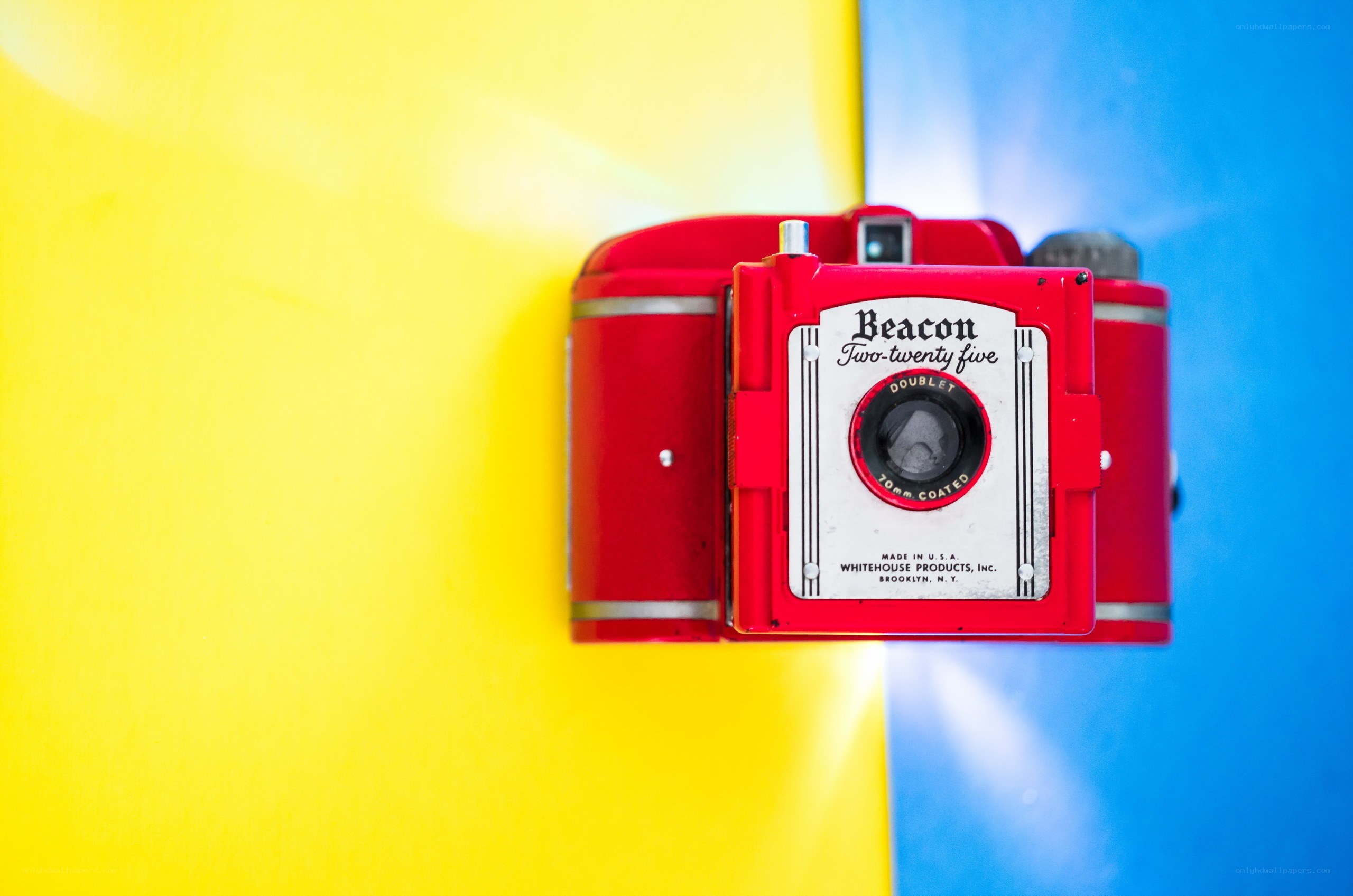 Red vintage camera on colorful background