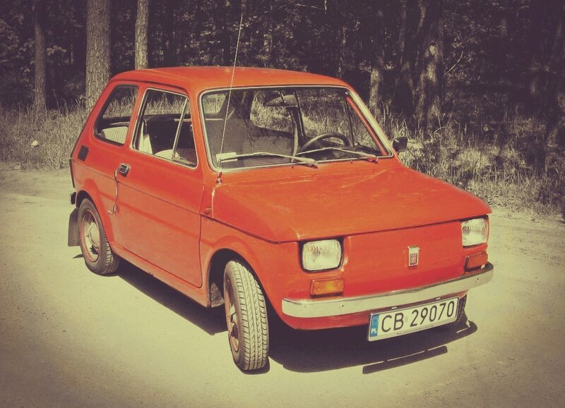 Red vintage car on a dirt road