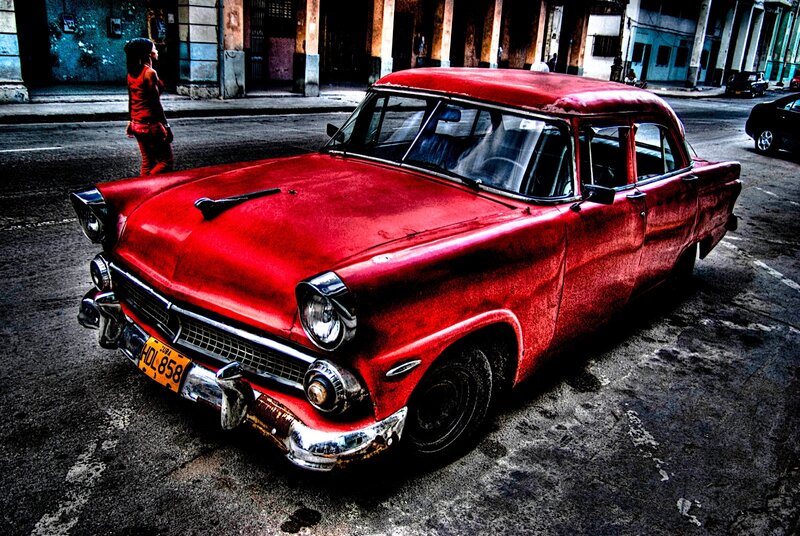 Red vintage car on city street