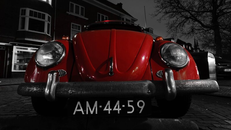 Red vintage car on cobblestone street