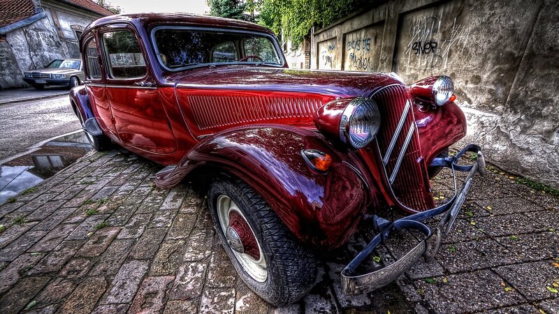 Red vintage car on cobblestones