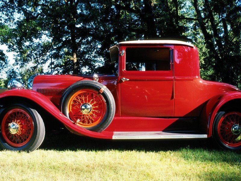 Red vintage car on grass