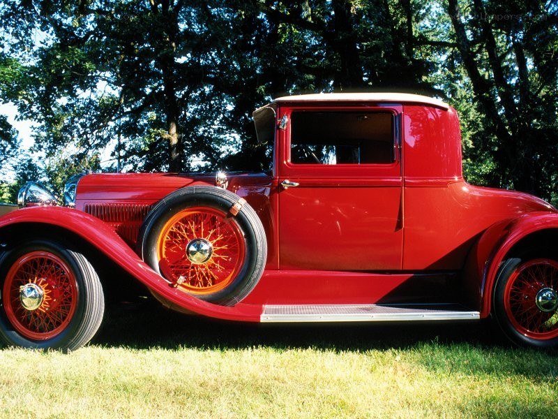 Red vintage car on grass