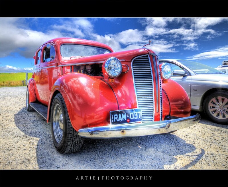 Red vintage car on gravel