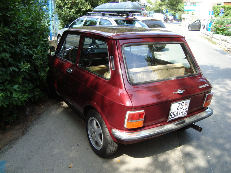 Red vintage car parked on street