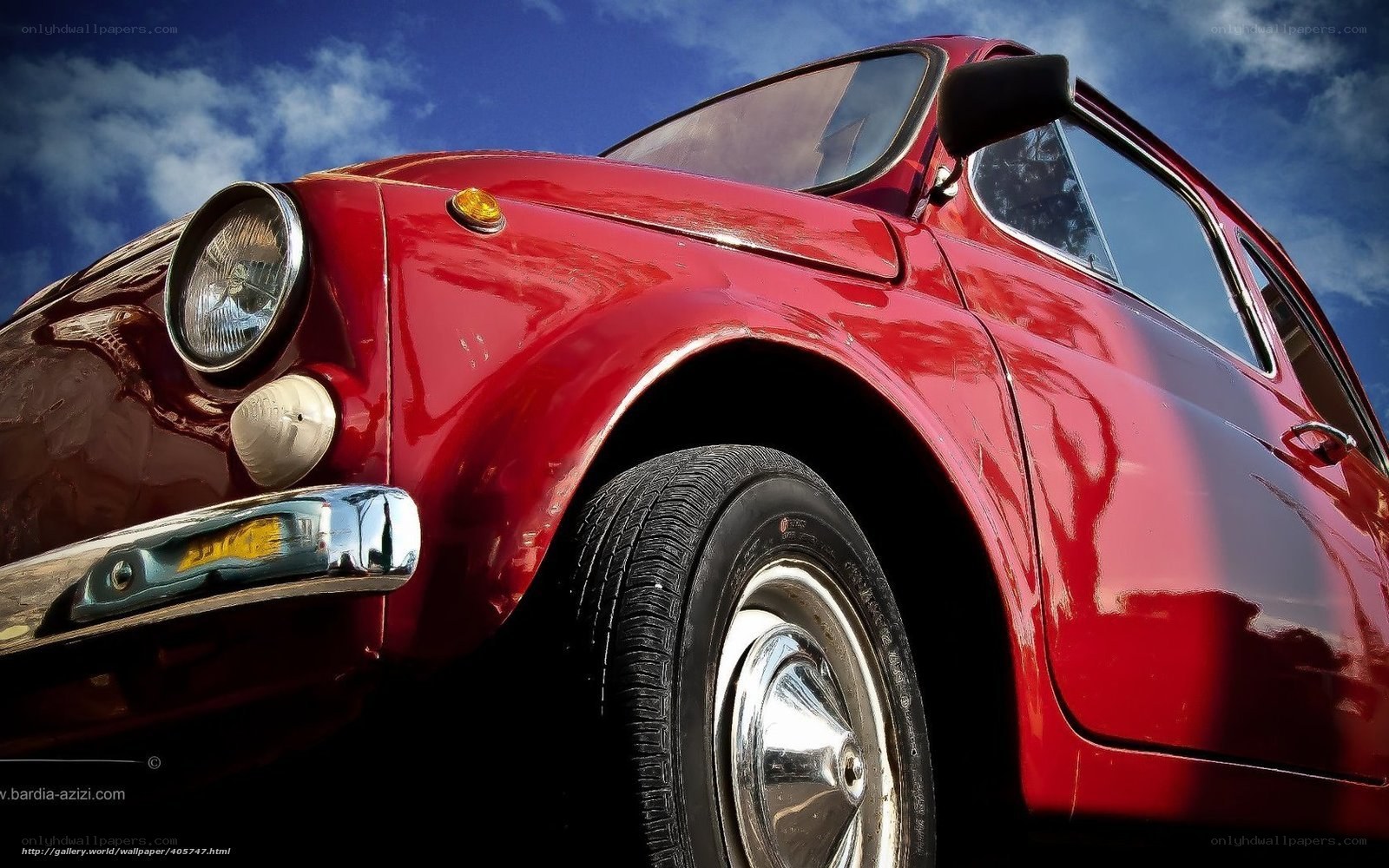 Red vintage car under blue sky