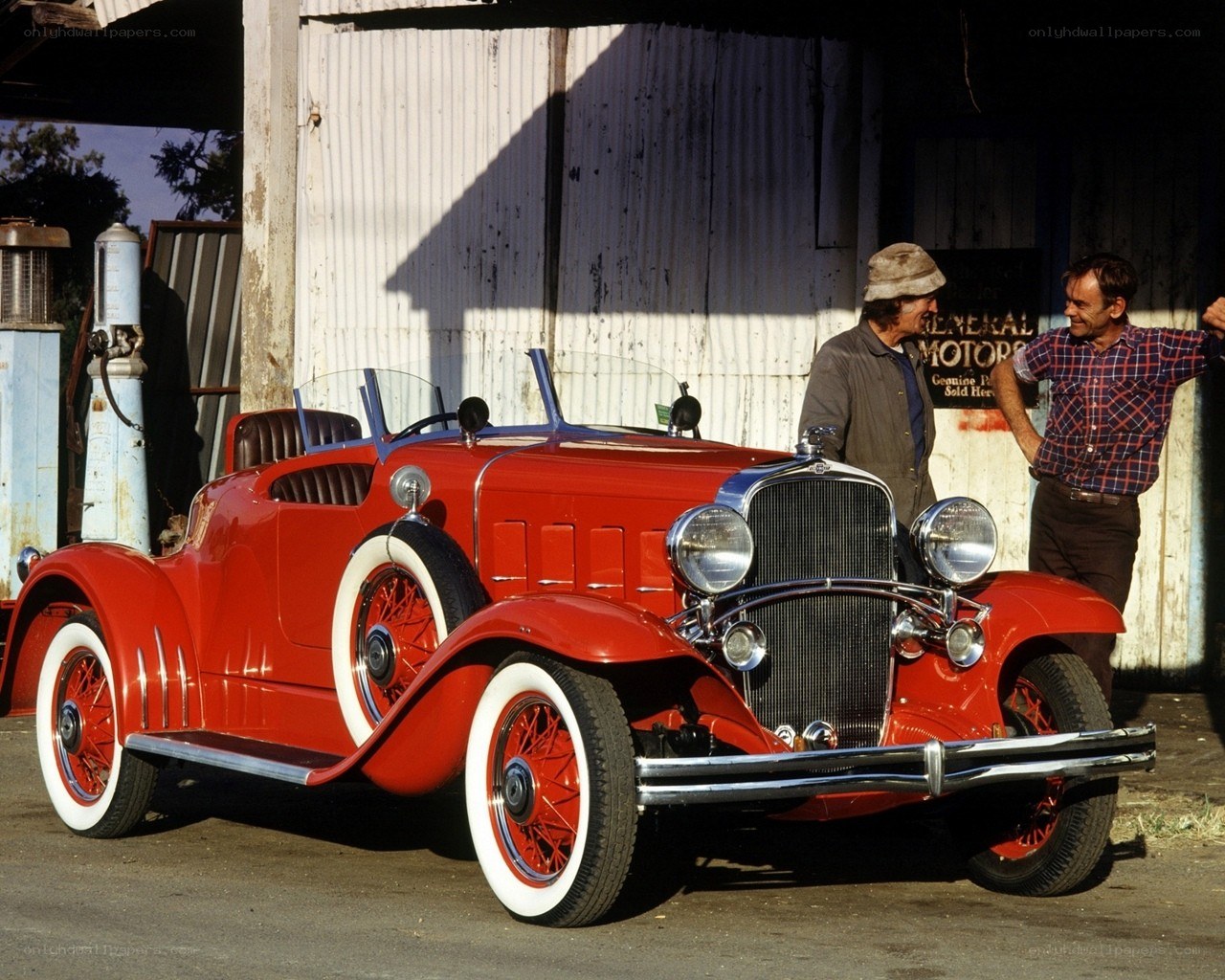 Red vintage car with two men