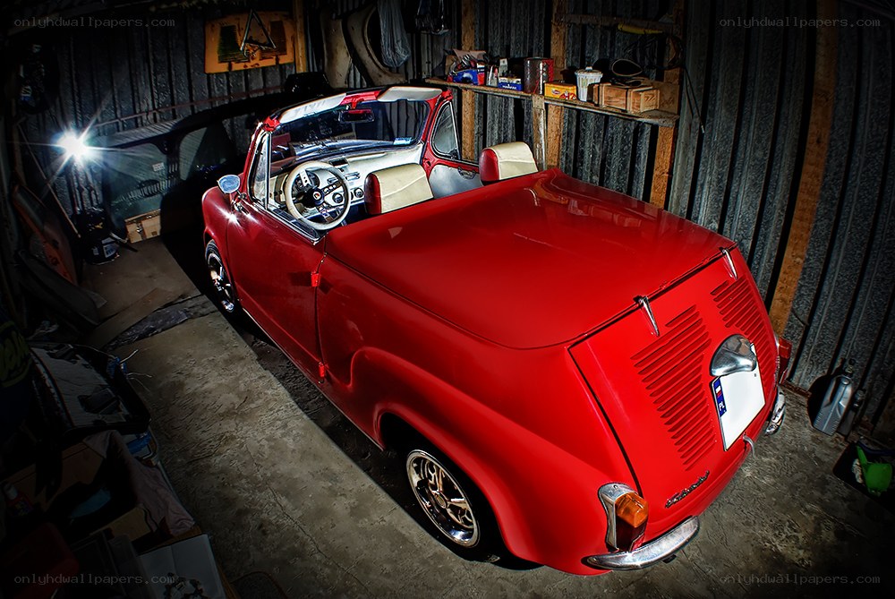 Red vintage convertible in garage