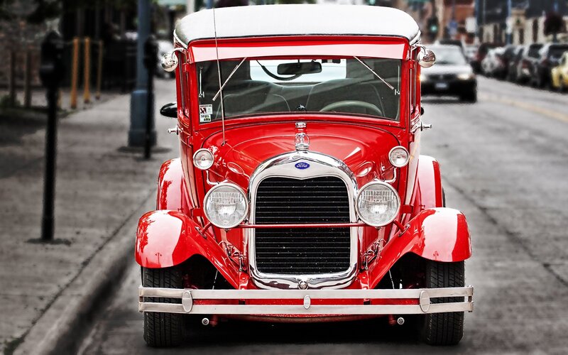 Red vintage Ford car on street
