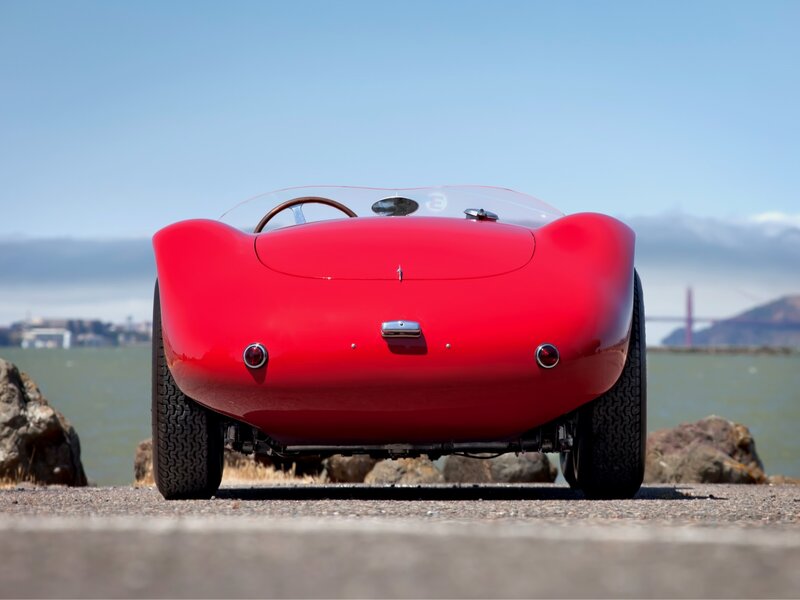 Red vintage race car by the bay