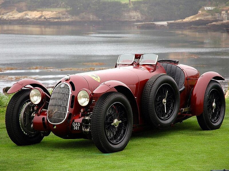 Red vintage race car on grass