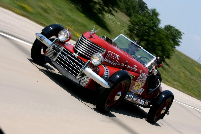Red vintage race car on track