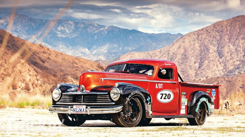 Red vintage race truck in mountains