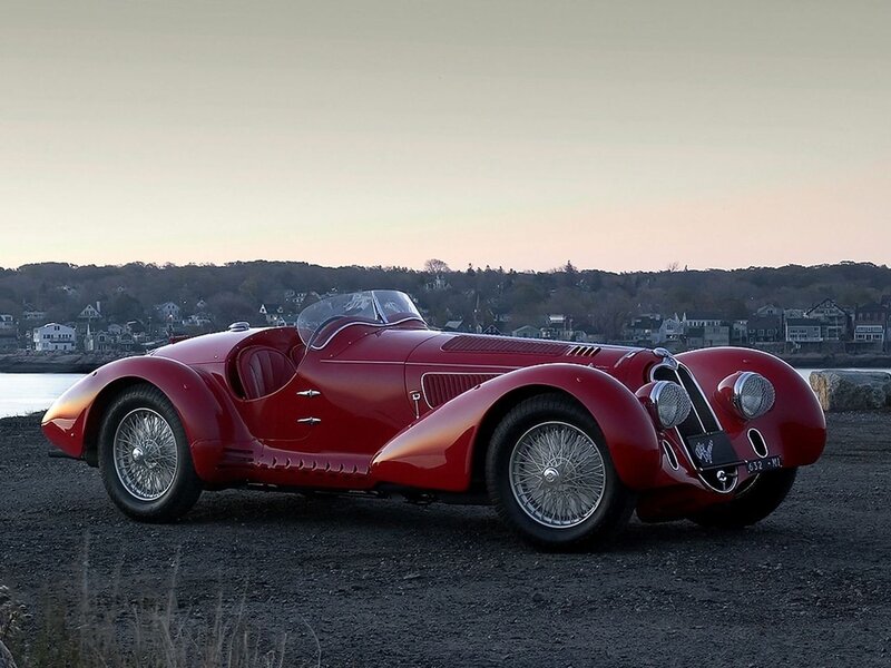 Red vintage sports car by the water