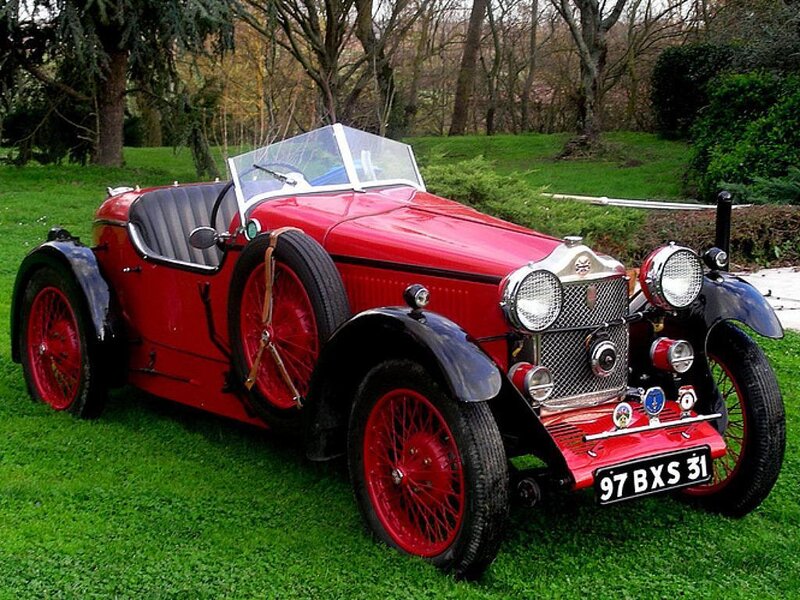 Red vintage sports car on grass