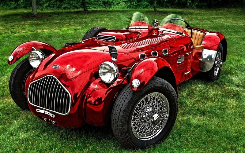 Red vintage sports car on grass