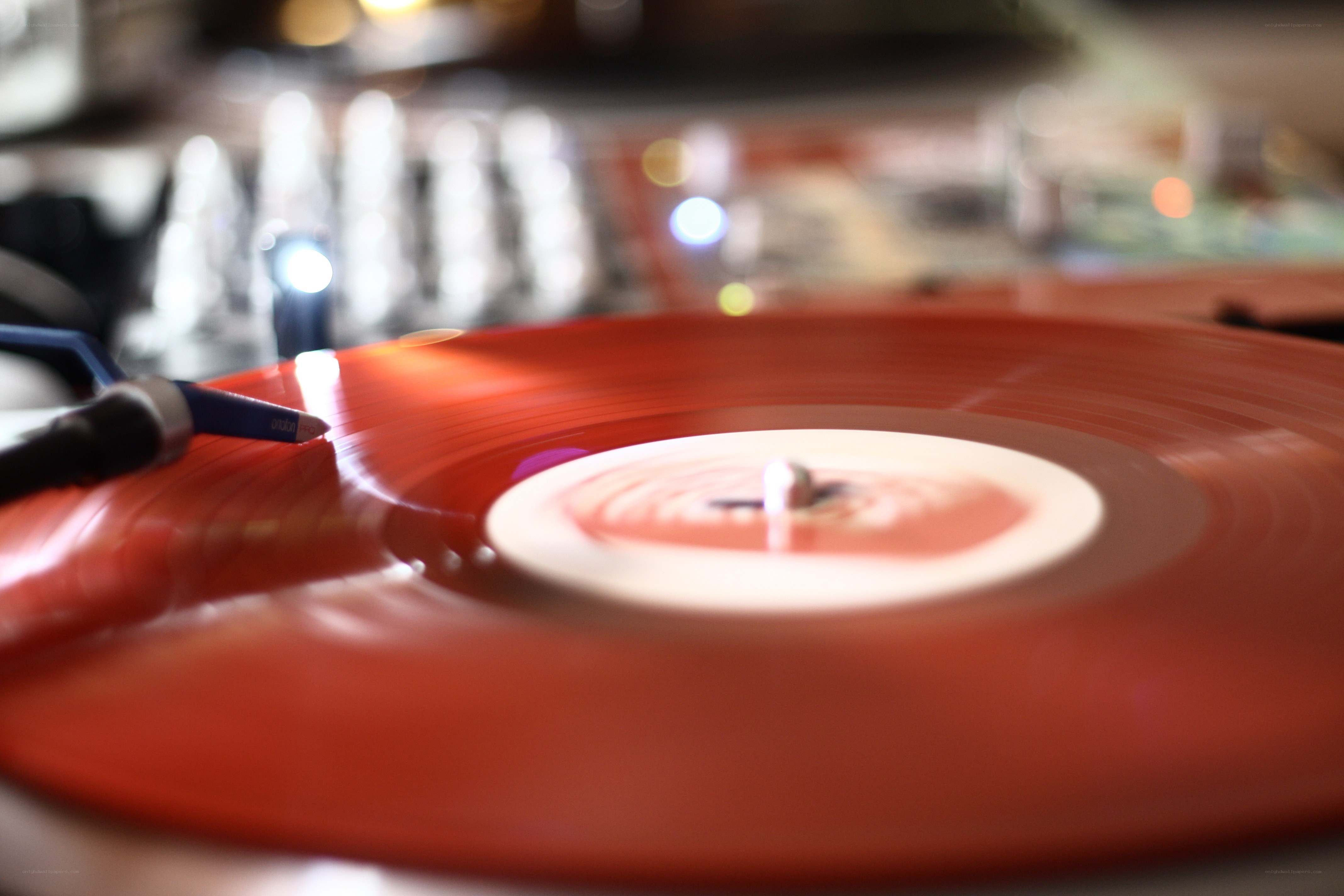 Red vinyl record on turntable