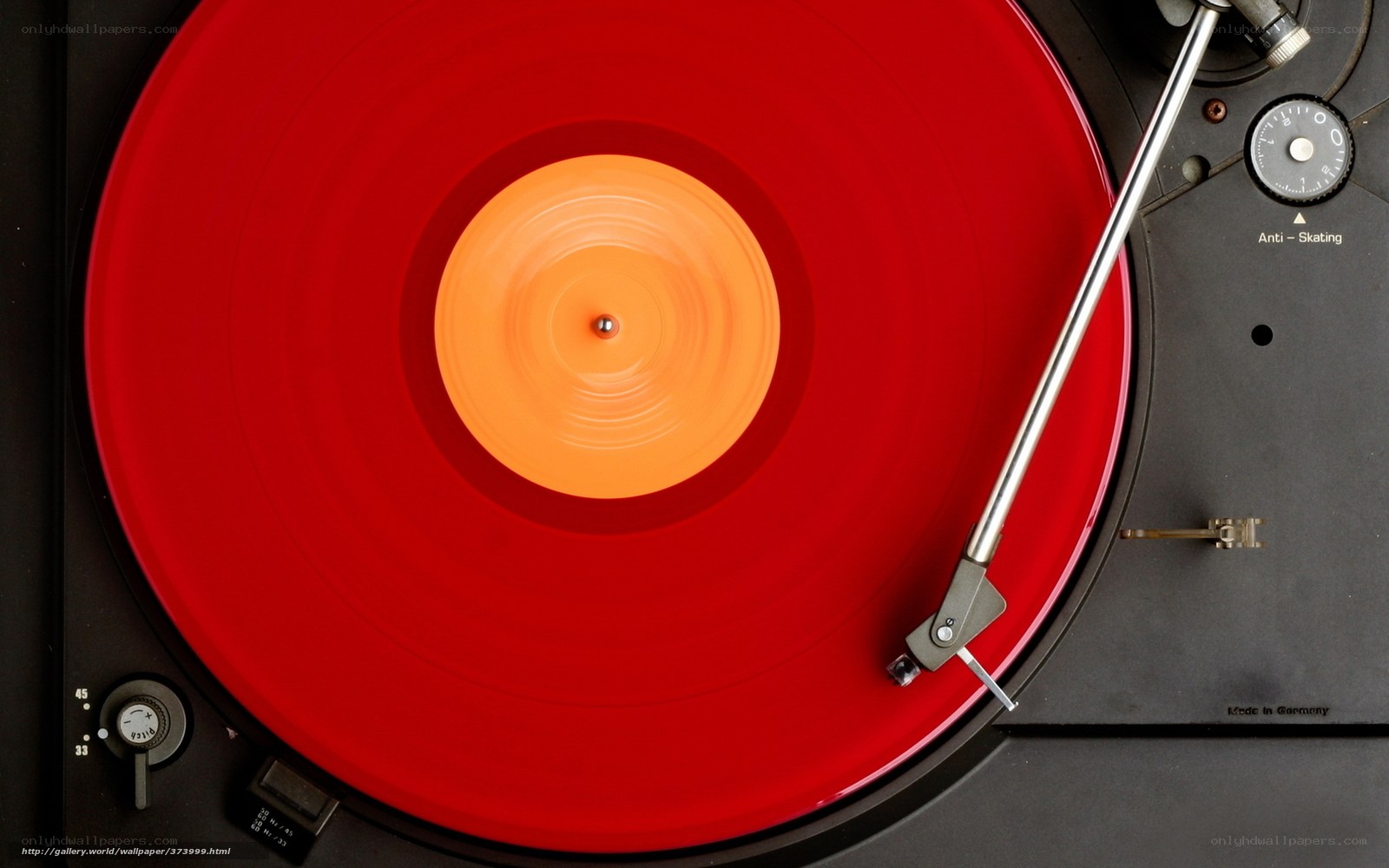 Red vinyl record on turntable