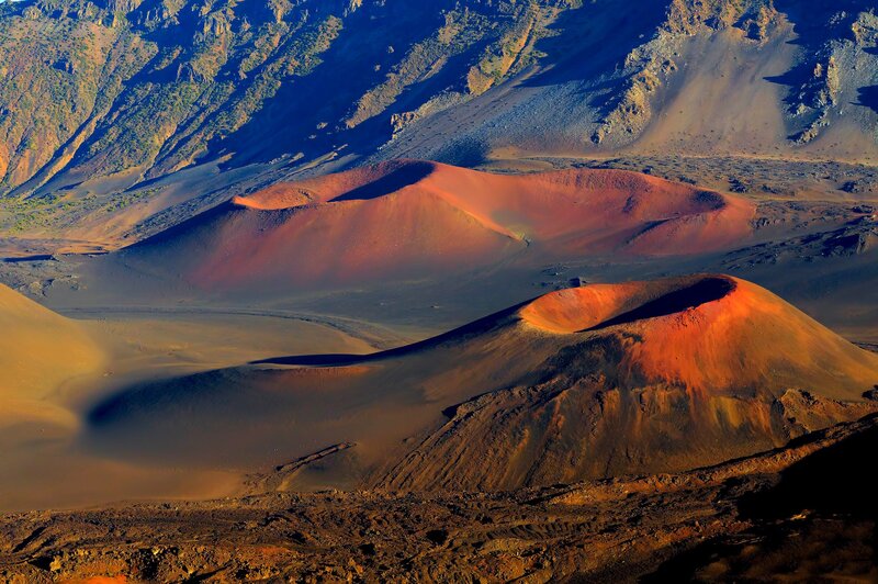 Red volcanic cones in a desert landscape