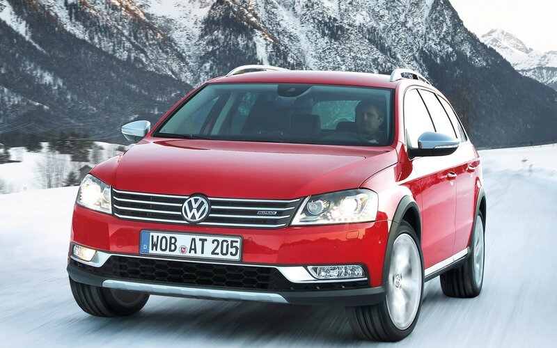 Red Volkswagen Alltrack on snowy road
