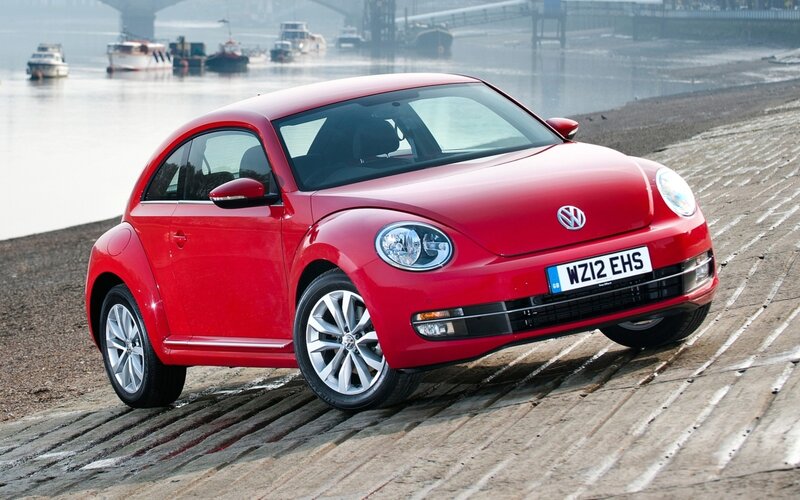 Red Volkswagen Beetle by the water