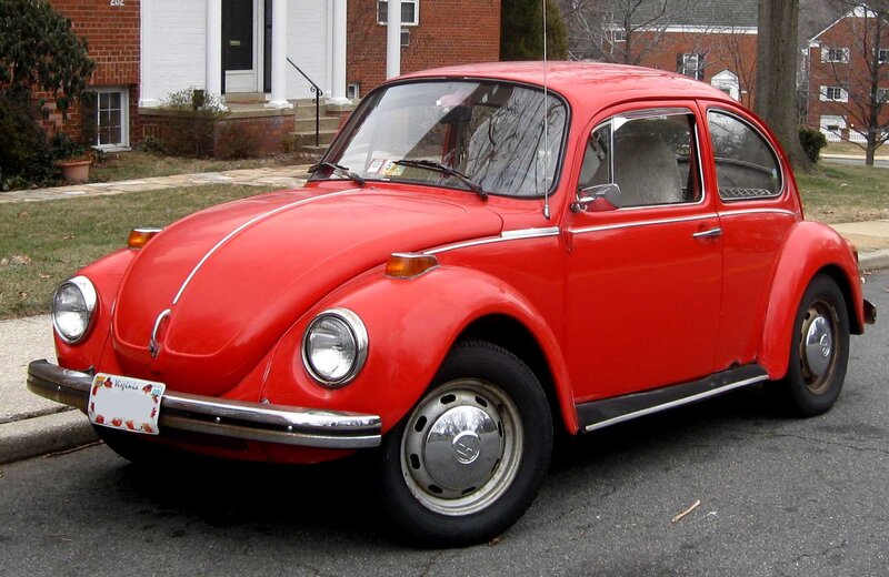 Red Volkswagen Beetle parked on street