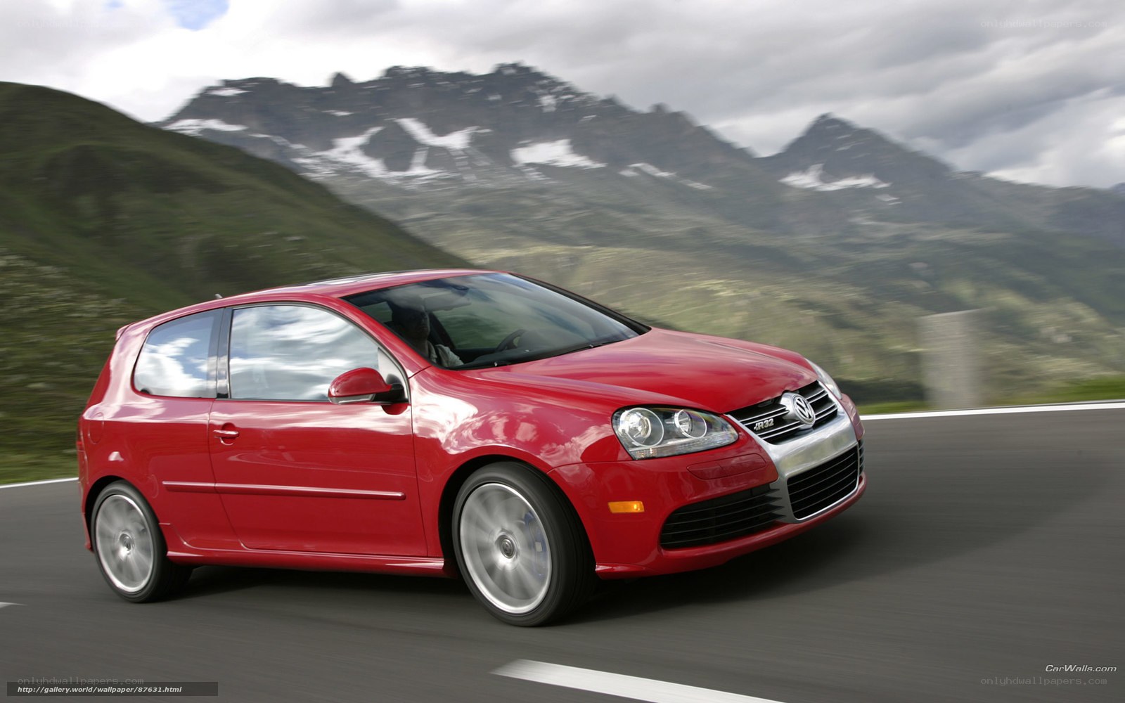 Red Volkswagen Golf GTI on mountain road