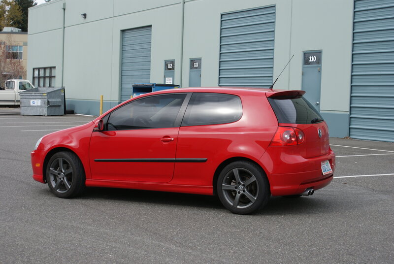 red volkswagen golf in parking lot
