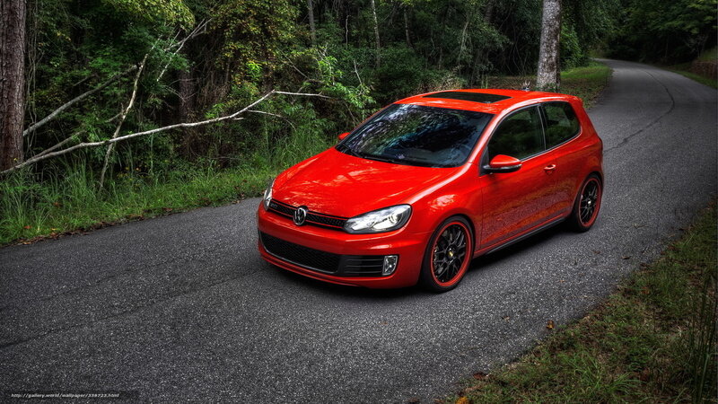 Red Volkswagen Golf on forest road