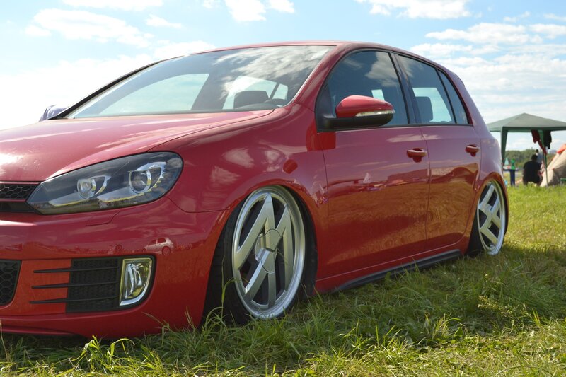 Red Volkswagen Golf on grass