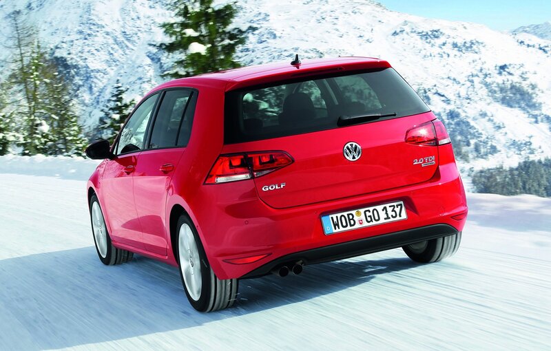 Red Volkswagen Golf on snowy road