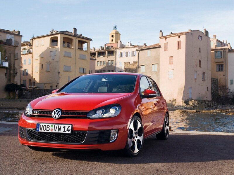 Red Volkswagen GTI by the water