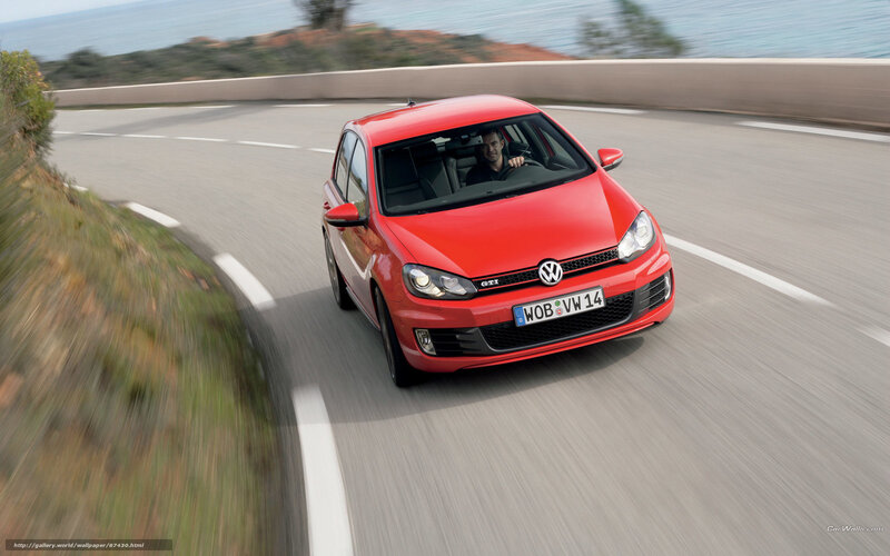 Red Volkswagen GTI on coastal road