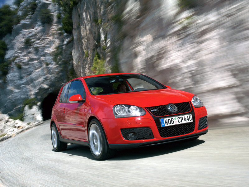 Red Volkswagen GTI on mountain road