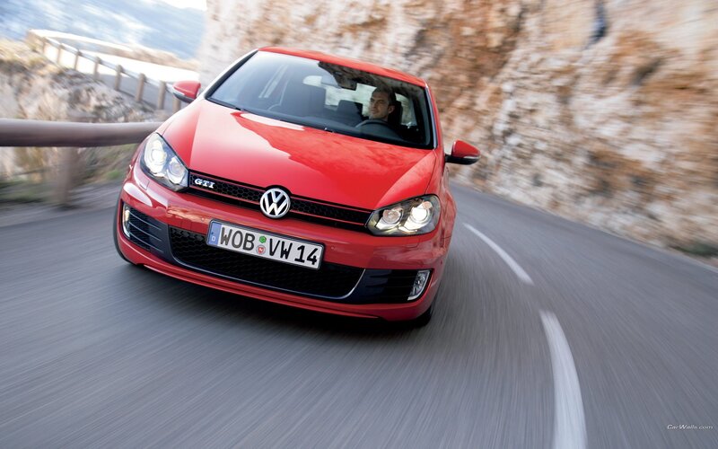 Red Volkswagen GTI on winding road
