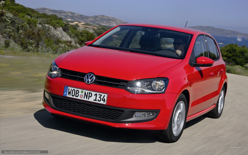 Red Volkswagen Polo driving on road